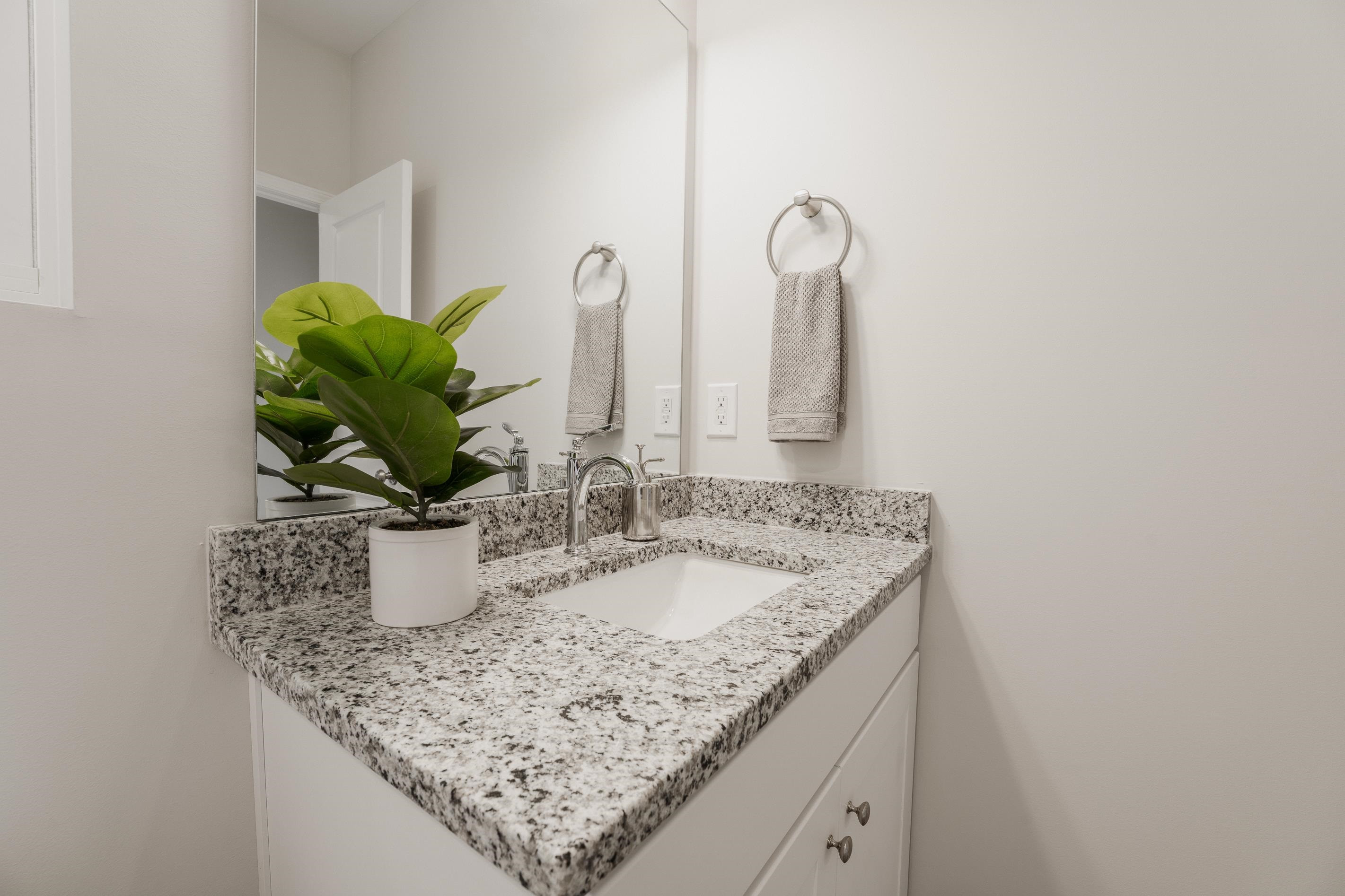 1309 Swingline Way Raleigh, NC 27610 - Photo 41 of 47 a bathroom with a granite countertop sink and a mirror