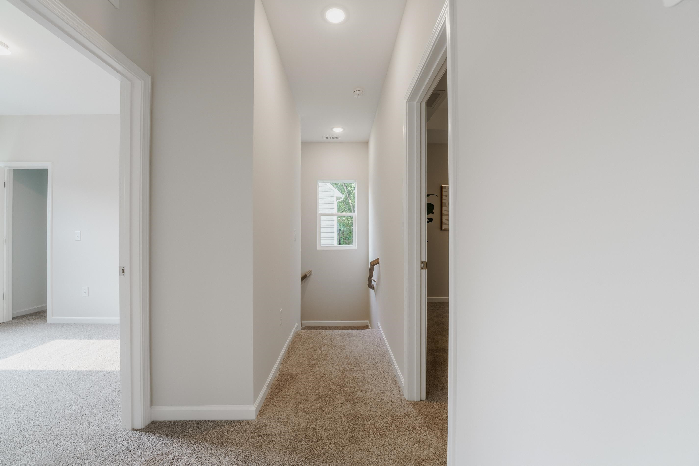 1309 Swingline Way Raleigh, NC 27610 - Photo 42 of 47 a view of a hallway with wooden shelves