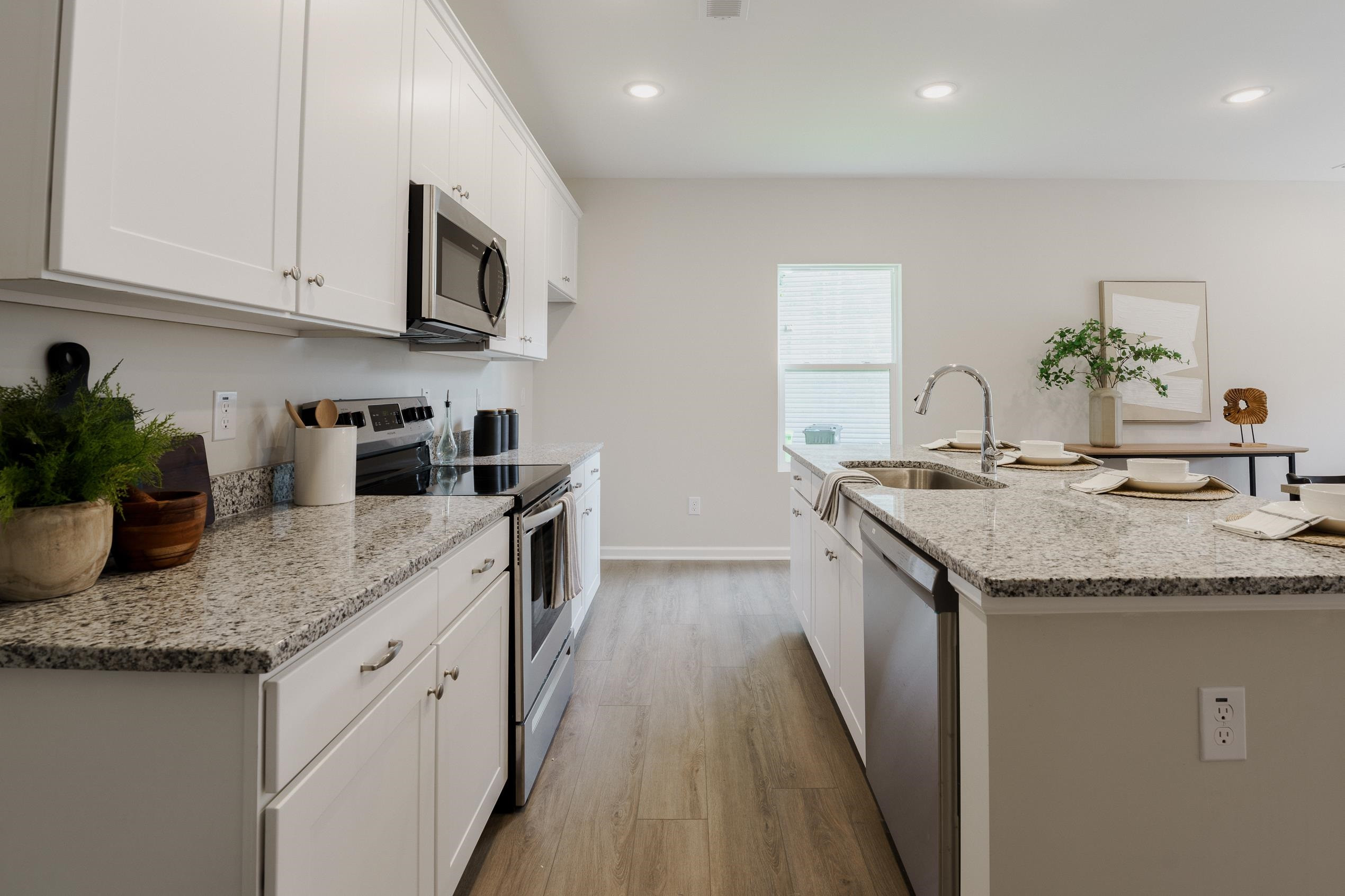 1309 Swingline Way Raleigh, NC 27610 - Photo 10 of 47 a kitchen with stainless steel appliances granite countertop a sink stove and cabinets