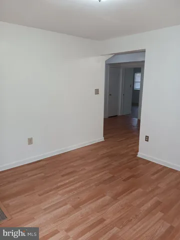 an empty room with wooden floor and closet