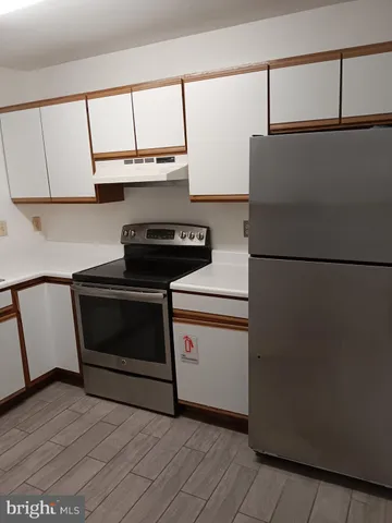 a stove top oven sitting inside of a kitchen