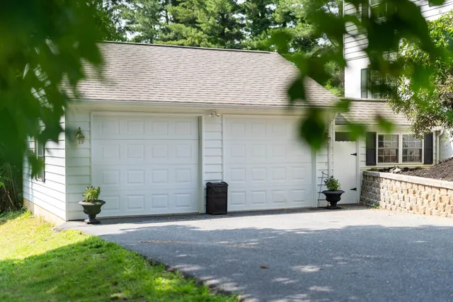 a view of a house with a yard and garage