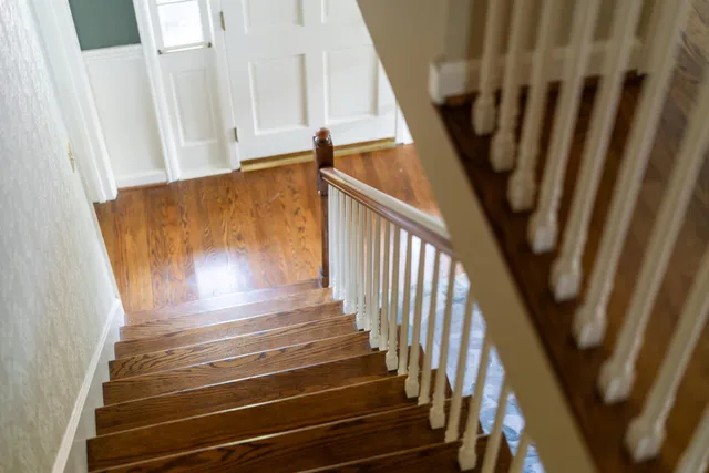 a bathroom with a granite countertop sink a toilet and a mirror