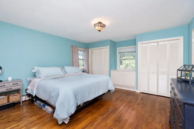 a bathroom with a granite countertop sink and a window