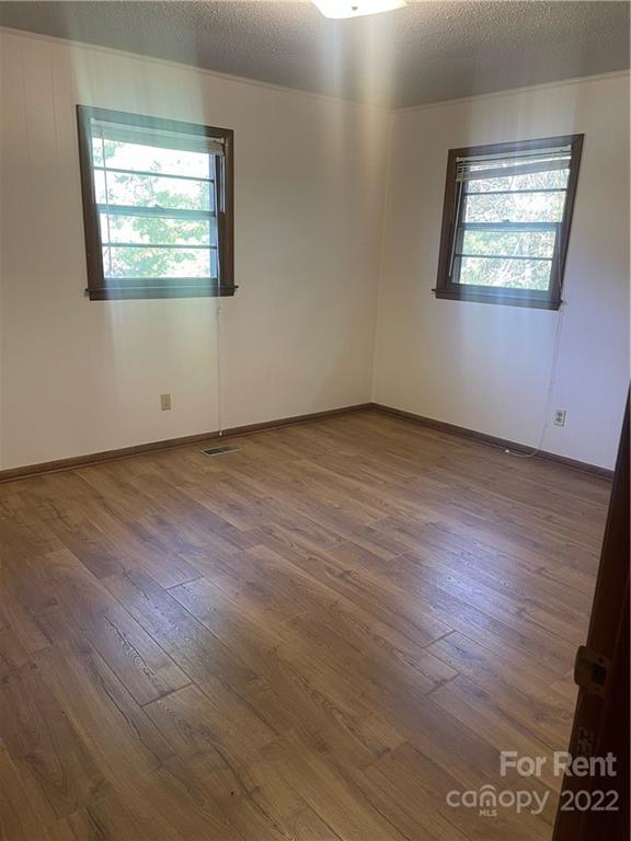 3538 Rudisill Road Newton, NC 28658 - Photo 12 of 20 an empty room with wooden floor and windows
