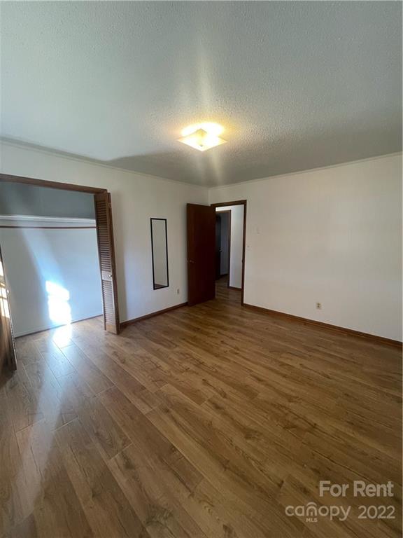 3538 Rudisill Road Newton, NC 28658 - Photo 13 of 20 an empty room with wooden floor and windows