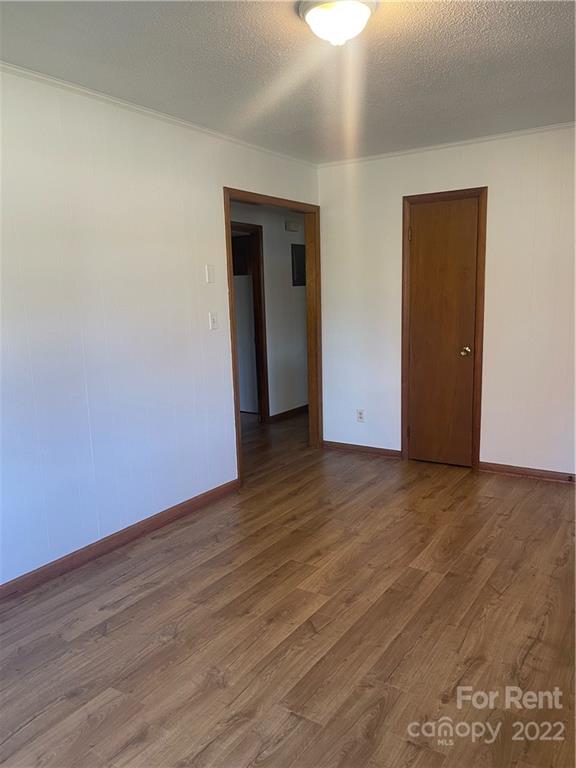 3538 Rudisill Road Newton, NC 28658 - Photo 7 of 20 a view of an empty room with wooden floor and closet