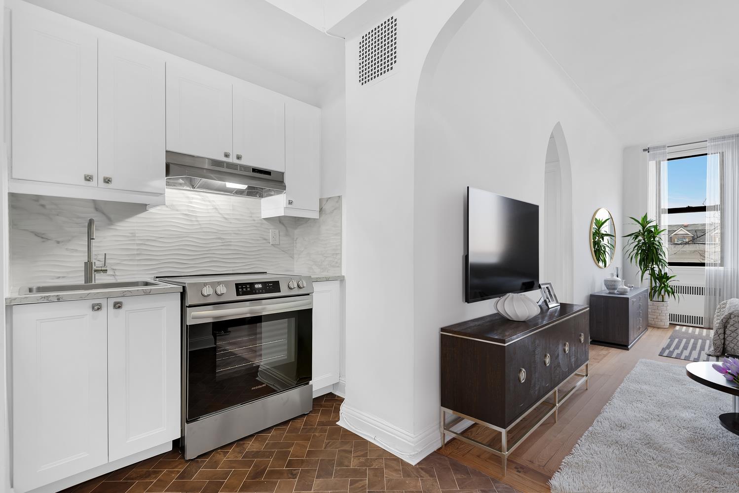 130 Bay Ridge Parkway, Unit 5K Brooklyn, NY 11209 - Photo 5 of 11 a kitchen with stainless steel appliances a stove a sink and a microwave