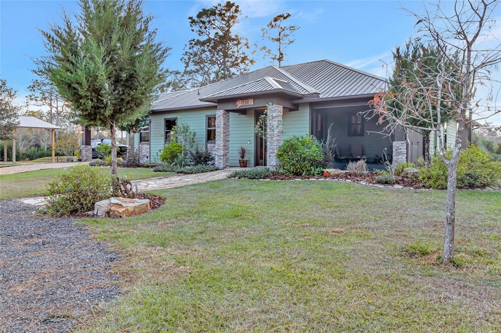 7330 Crabgrass Road St. Cloud, FL 34773 - Photo 55 of 60 a front view of a house with garden