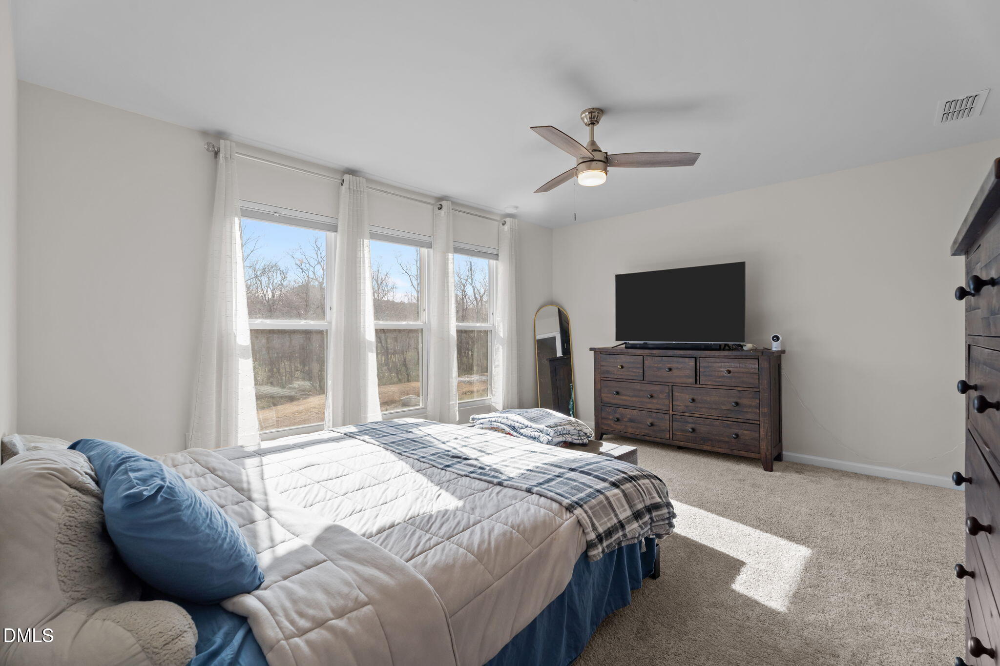 1572 Rhodes Pond Street Wendell, NC 27591 - Photo 17 of 44 a bedroom with a bed and a flat screen tv