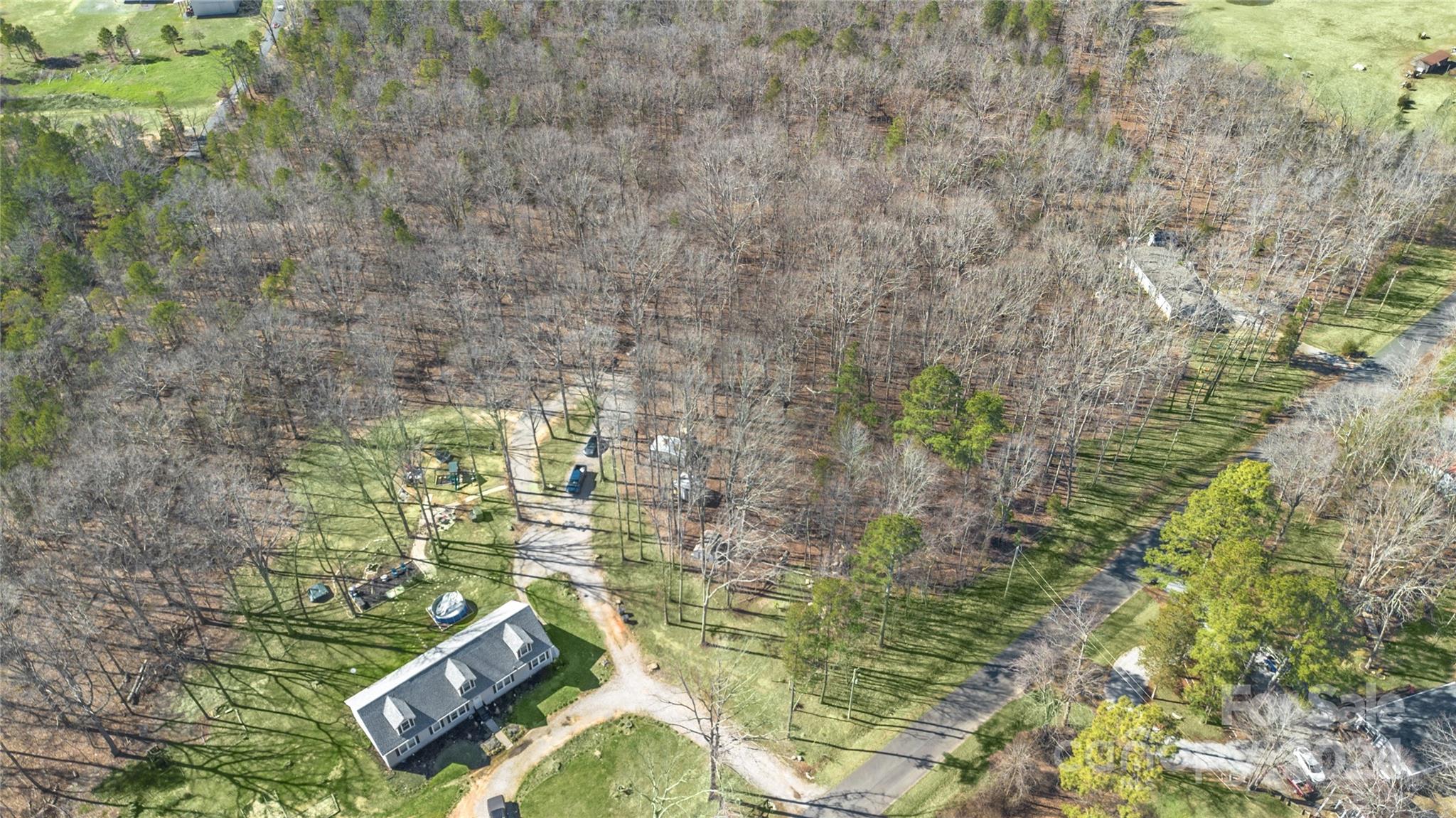 a aerial view of a residential houses with yard