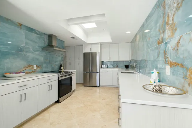a kitchen with a refrigerator sink and white cabinets