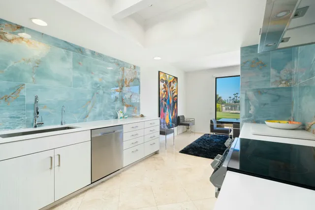 a kitchen with a stove sink and cabinets