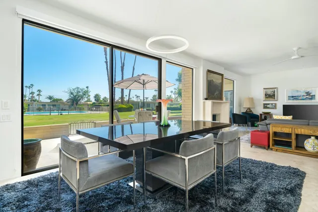 a living room with furniture and a floor to ceiling window