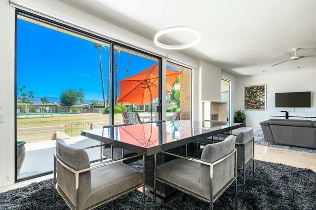 a bathroom with a granite countertop sink a large mirror and a shower