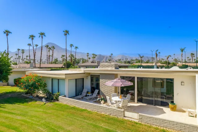 a view of a patio with a table & chairs