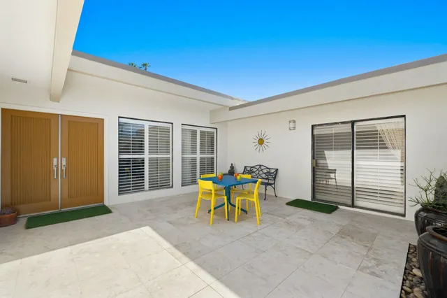 a view of a house with outdoor seating