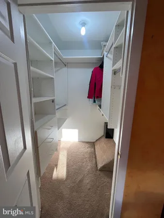 a bedroom with a bed and a mirror