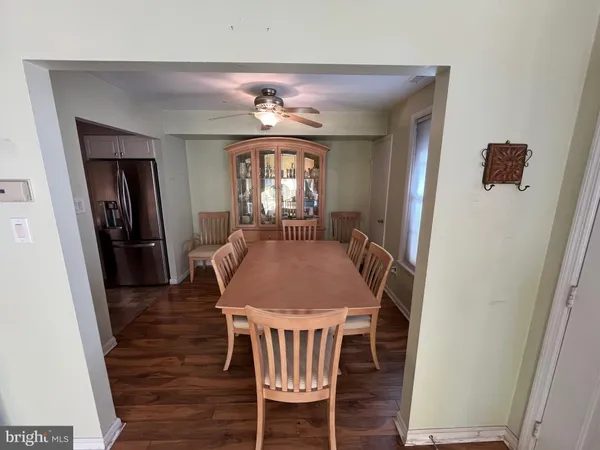 a dining room with furniture a chandelier and wooden floor