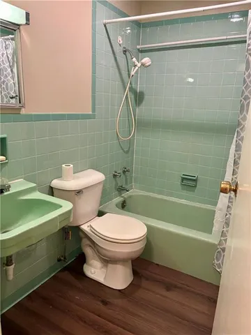 a bathroom with a toilet sink and shower