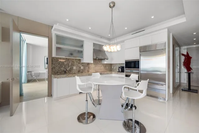 a kitchen with stainless steel appliances granite countertop a sink and cabinets