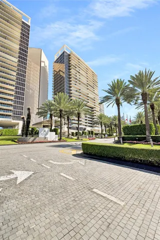 a view of a tall building next to a yard