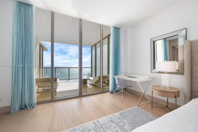 a living room with furniture and a floor to ceiling window