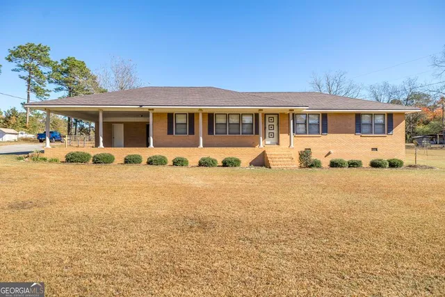 a front view of a house with yard patio and fire pit