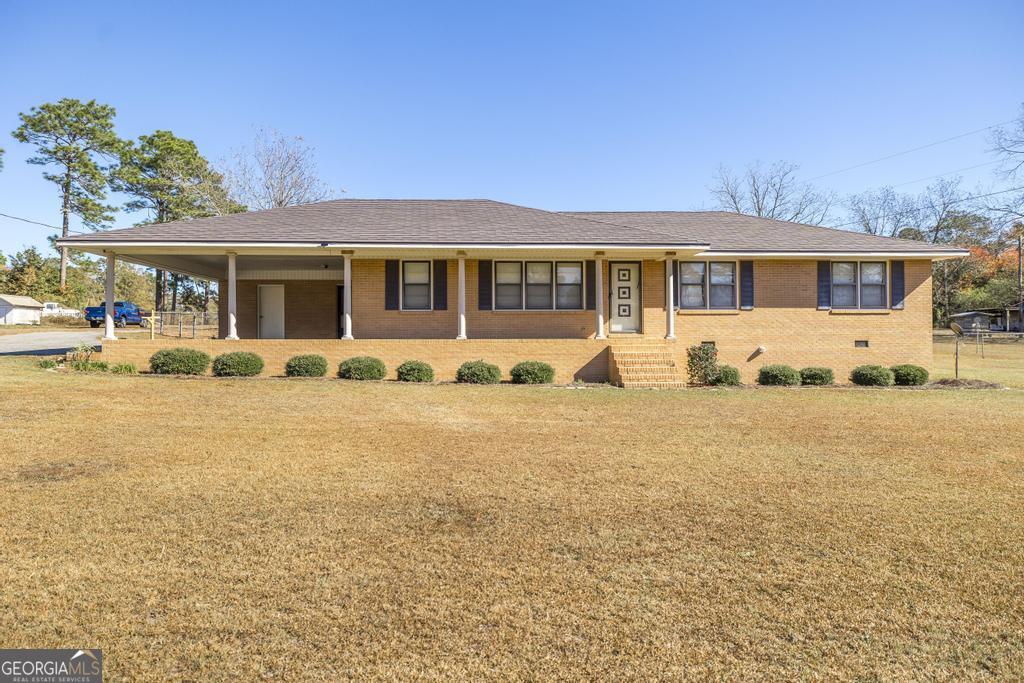 a front view of a house with yard patio and fire pit