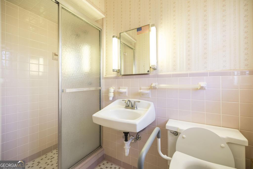 172 Old Eastman Road Cochran, GA 31014 - Photo 15 of 60 a bathroom with a sink a toilet and a mirror