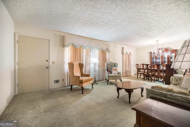 a living room with furniture and a floor to ceiling window