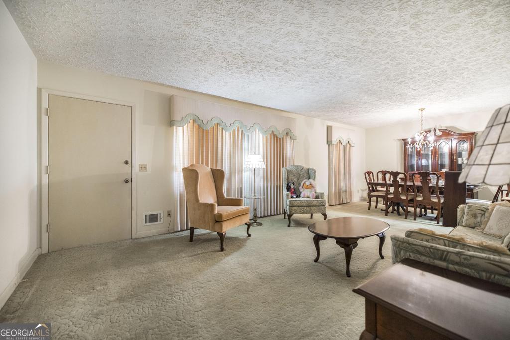 172 Old Eastman Road Cochran, GA 31014 - Photo 2 of 60 a living room with furniture and a floor to ceiling window