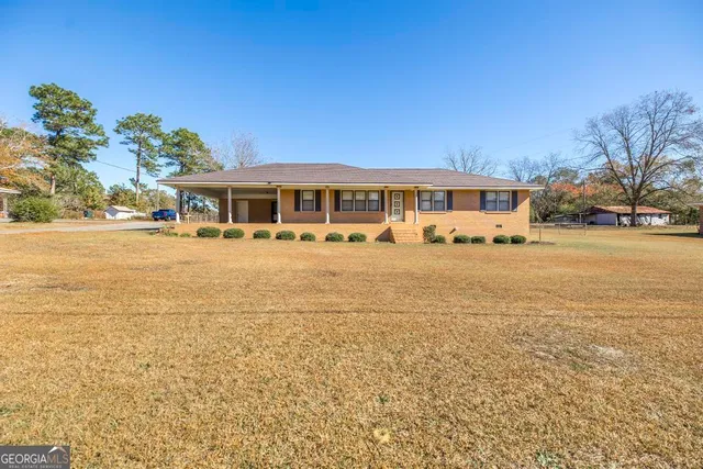 a kitchen with granite countertop a sink stainless steel appliances and cabinets