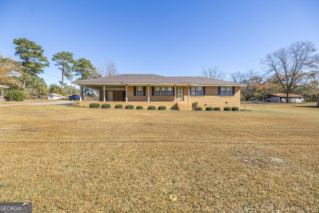 172 Old Eastman Road Cochran, GA 31014 - Photo 23 of 60 a front view of a house with a yard