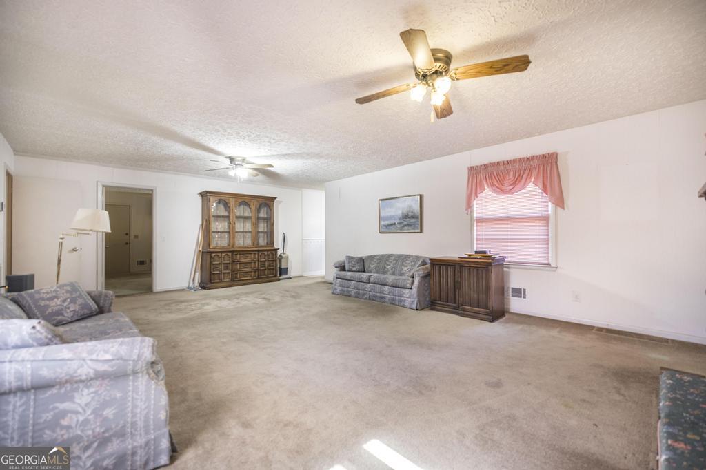 172 Old Eastman Road Cochran, GA 31014 - Photo 25 of 60 a living room with furniture and a ceiling fan