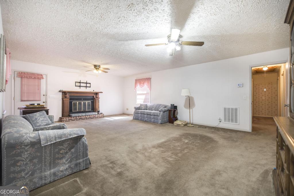 172 Old Eastman Road Cochran, GA 31014 - Photo 26 of 60 a living room with furniture and a fireplace