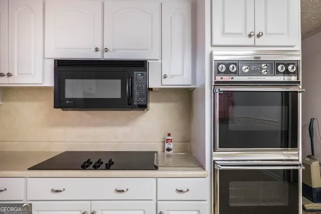 a view of staircase with white walls