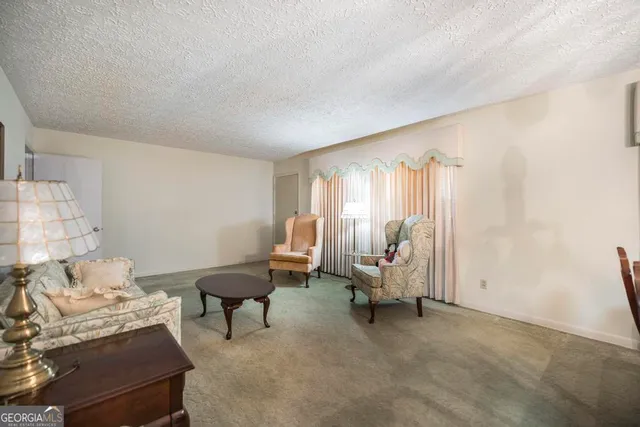 a bedroom with workspace and a couch