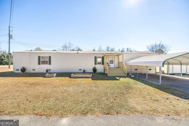 a living room with furniture a ceiling fan and a window