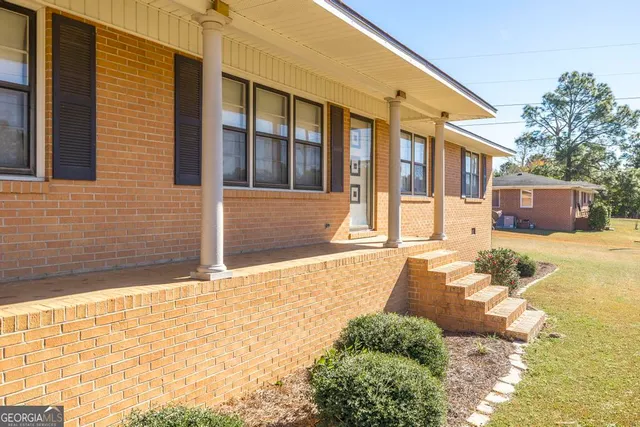 a view of a house with snow on the road
