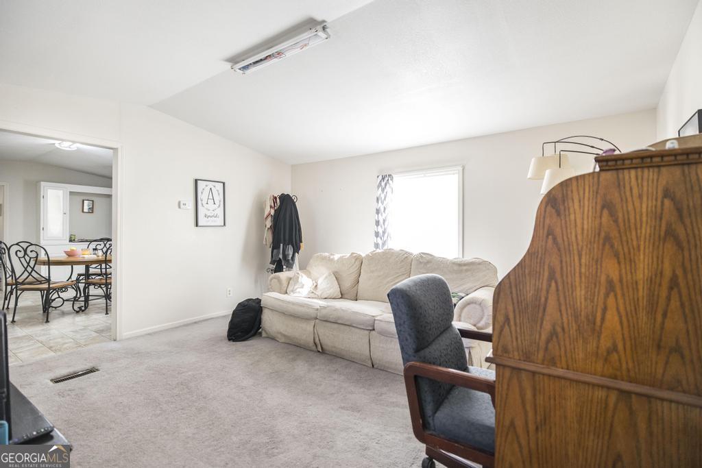 172 Old Eastman Road Cochran, GA 31014 - Photo 42 of 60 a living room with furniture a ceiling fan and a window