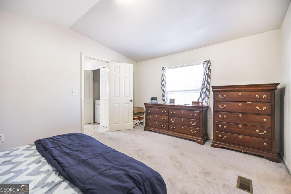 172 Old Eastman Road Cochran, GA 31014 - Photo 55 of 60 a bedroom with a bed and a dresser
