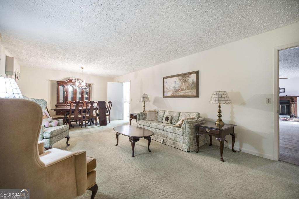 172 Old Eastman Road Cochran, GA 31014 - Photo 6 of 60 a living room with furniture and couches with wooden floor