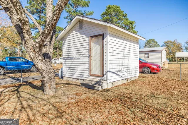 a view of yard with tree in the background