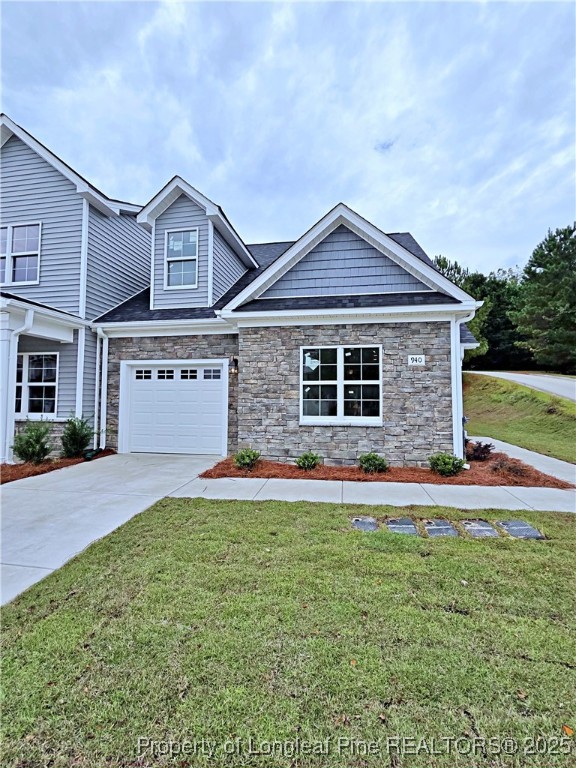 940 Kensington Park Road Fayetteville, NC 28311 - Photo 1 of 38 a front view of a house with a yard and garage