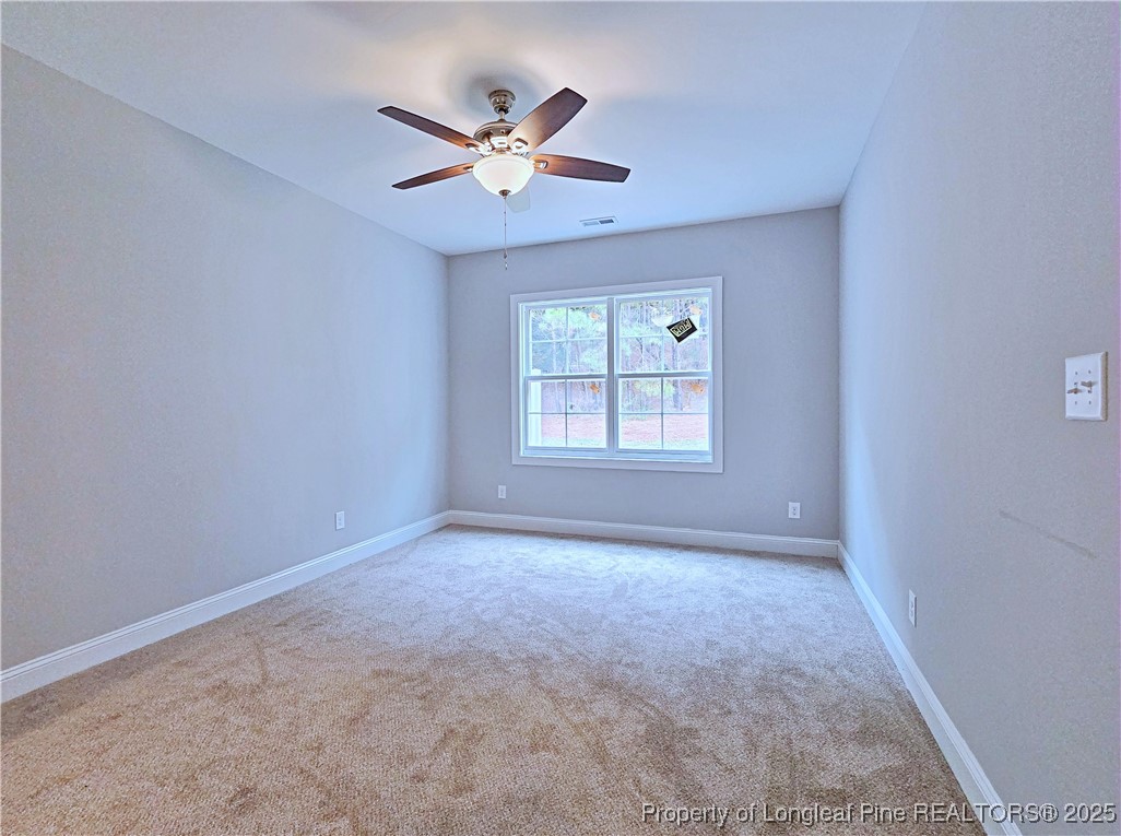 940 Kensington Park Road Fayetteville, NC 28311 - Photo 15 of 41 an empty room with windows and fan