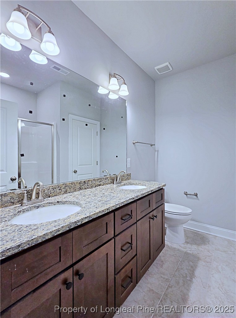 940 Kensington Park Road Fayetteville, NC 28311 - Photo 18 of 41 a bathroom with a granite countertop double vanity sink and a mirror