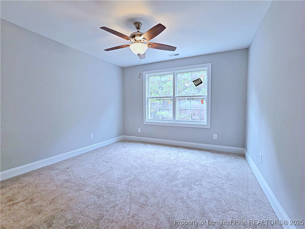 940 Kensington Park Road Fayetteville, NC 28311 - Photo 25 of 41 an empty room with ceiling fan and windows