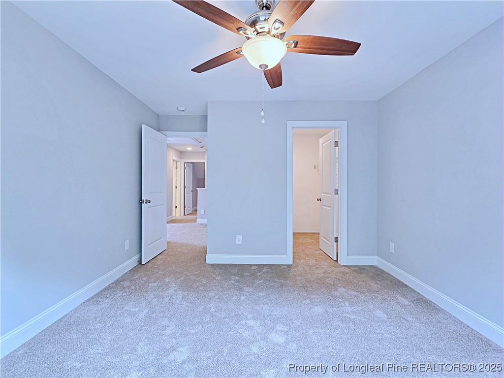 940 Kensington Park Road Fayetteville, NC 28311 - Photo 26 of 41 an empty room with closet and fan
