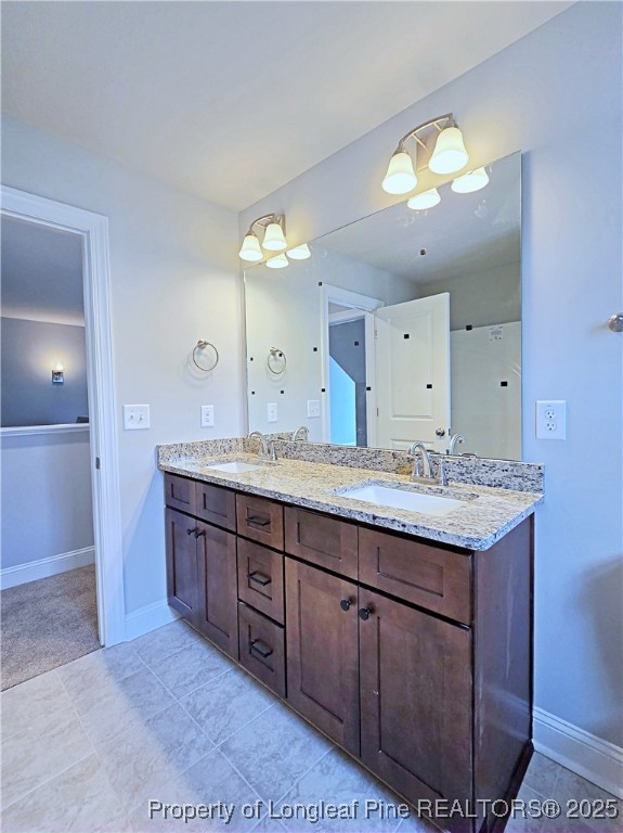 940 Kensington Park Road Fayetteville, NC 28311 - Photo 27 of 38 a bathroom with a granite countertop sink and a mirror
